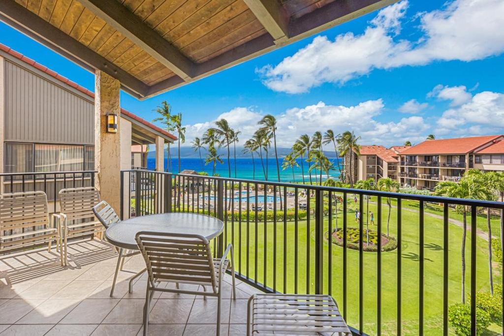 a balcony with a table and chairs and the ocean at Maui Westside Presents: Papakea J401 Top floor Ocean Views in Lahaina
