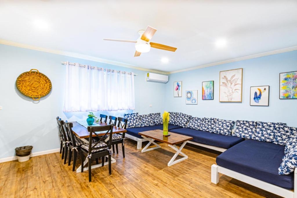 a living room with a blue couch and a table at Sunset Cottage at Viking Hill in Nassau