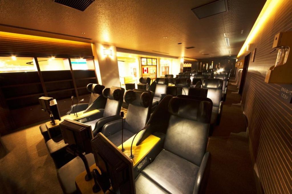 a room with a bunch of seats in a theater at Spa World HOTEL&RESORT in Osaka