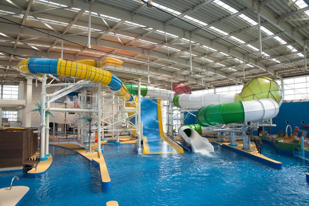a large indoor water park with a water slide at Spa World HOTEL&RESORT in Osaka