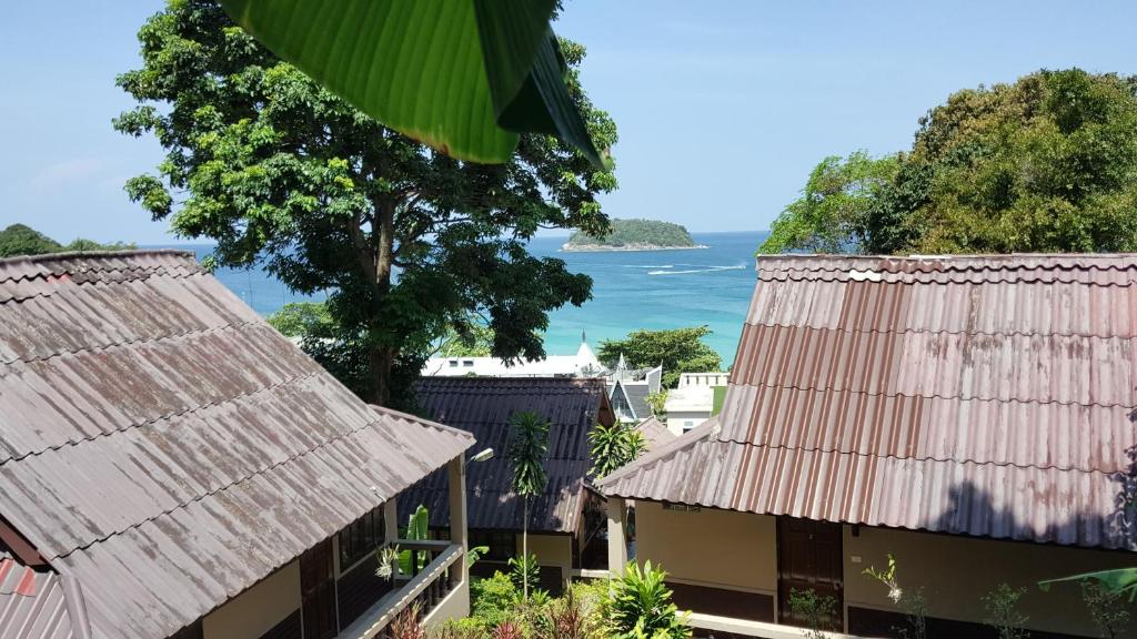 a view of the ocean from the roofs of buildings at Kata Beachwalk Hotel and Bungalows in Kata Beach