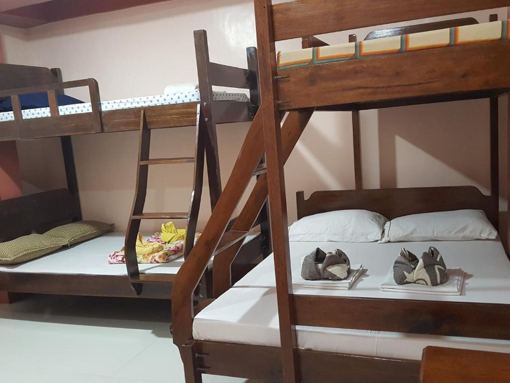 a room with two bunk beds with hats on them at D'MESA Seacretlodge and Restaurant in Taytay
