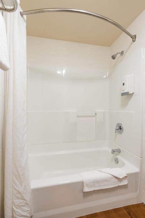a white bathroom with a tub and a shower at Pea Soup Andersen's Inn in Buellton