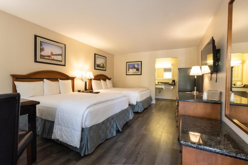 a hotel room with two beds and a television at Pea Soup Andersen's Inn in Buellton
