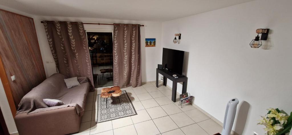 TV a/nebo společenská místnost v ubytování Le Lis Vacances et Affaire Cosy vue Mer