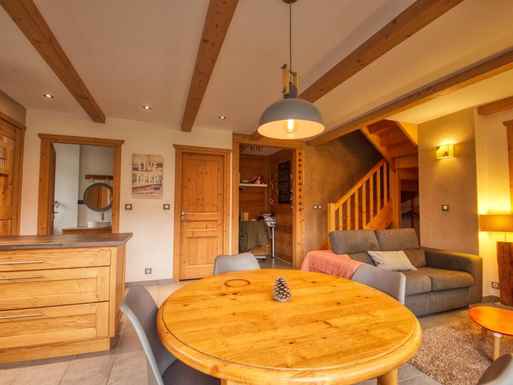 a kitchen and living room with a wooden table at Appartement Samoëns, 3 pièces, 4 personnes - FR-1-642-77 in Samoëns