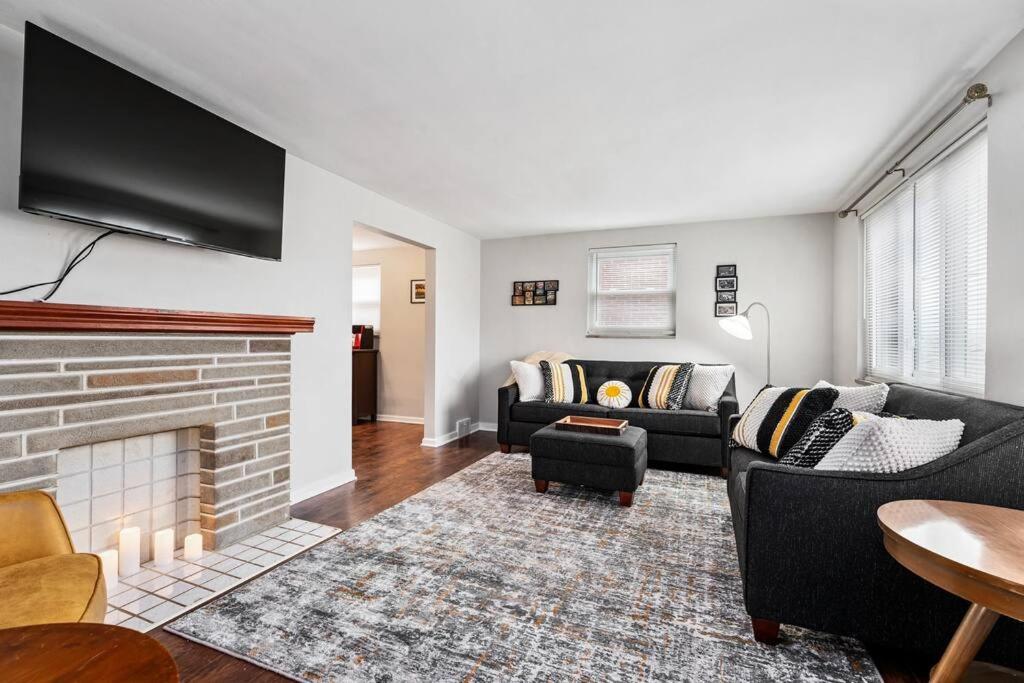a living room with a couch and a fireplace at Spacious Home, 15min from Downtown, Private Garage & Patio in Pittsburgh