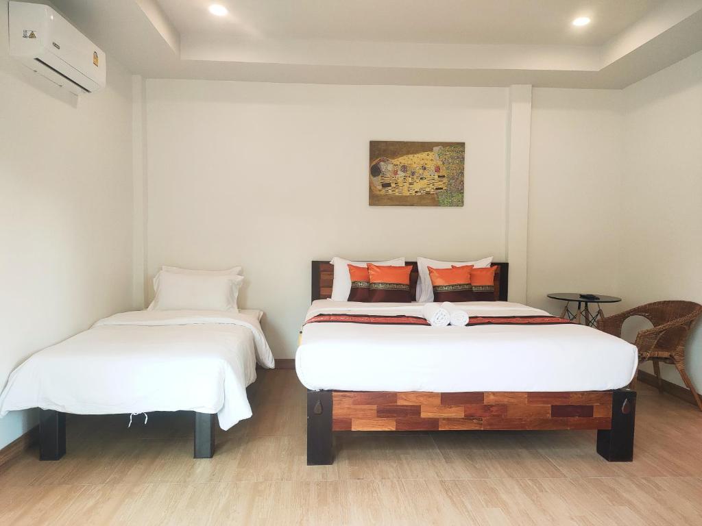 Postel nebo postele na pokoji v ubytování Himaphan Boutique Resort - SHA EXTRA PLUS