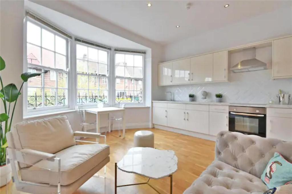 a living room with a couch and a table at Private 2 Bed Apartment / HUGE OUTDOOR TERRACE in London