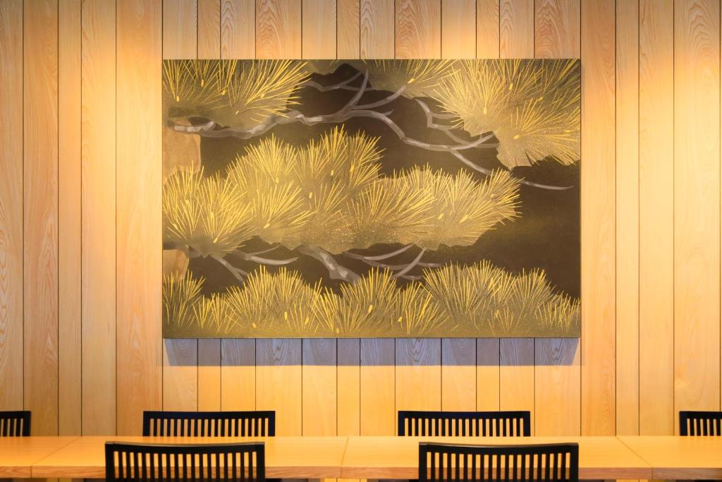 a painting on the wall of a restaurant with chairs at Waqoo Naritasanmonzen in Narita