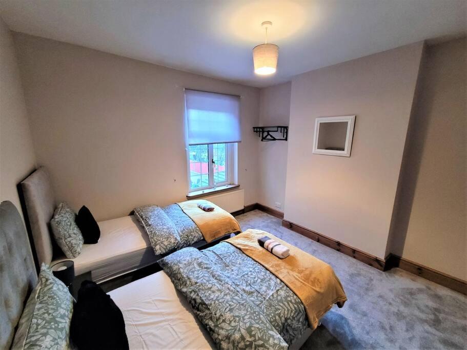 a bedroom with two beds and a window at Nice 4-bedroom vacation home with indoor fireplace in Wellington