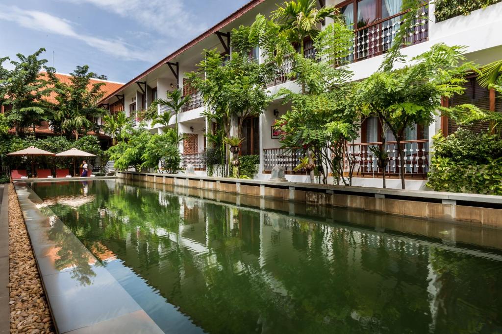 a canal in front of a building at Montra Nivesha residence and Art in Siem Reap