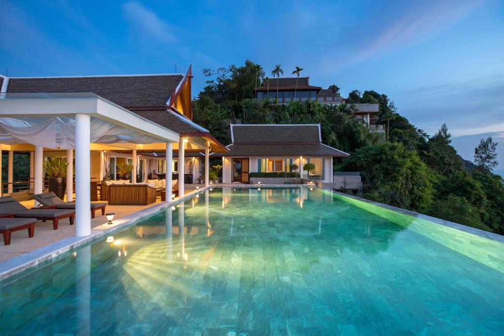 a swimming pool in front of a villa at Ayara Villa 3 - Unique Gem with Private Pool and Majestic Sea Views in Amphoe Thalang
