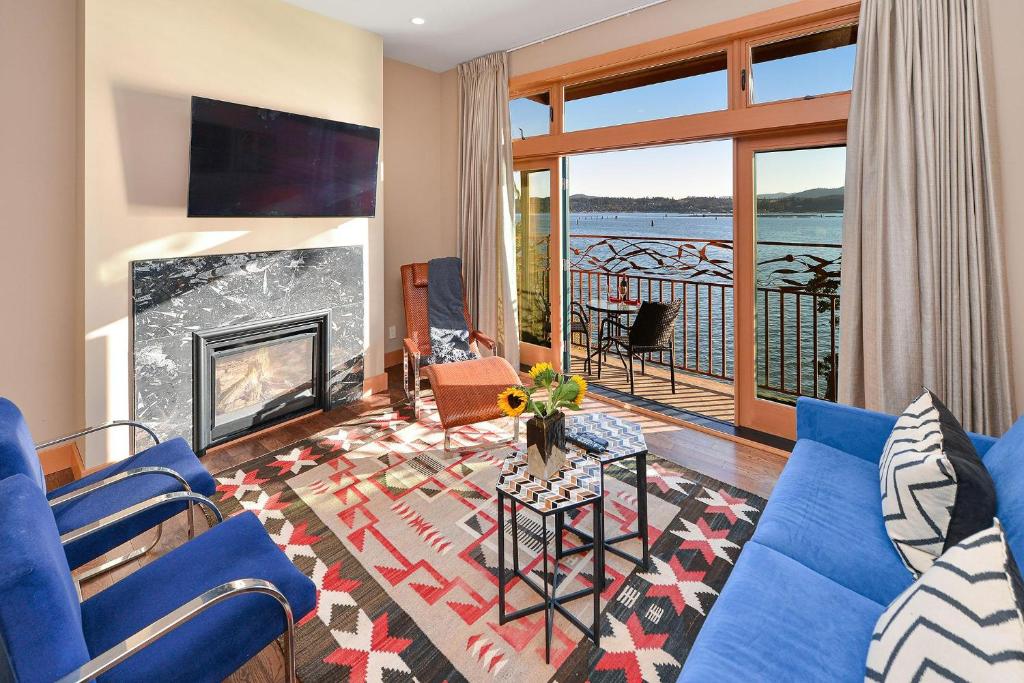 a living room with a blue couch and a fireplace at Salishan Chief Suite in Cowichan Bay