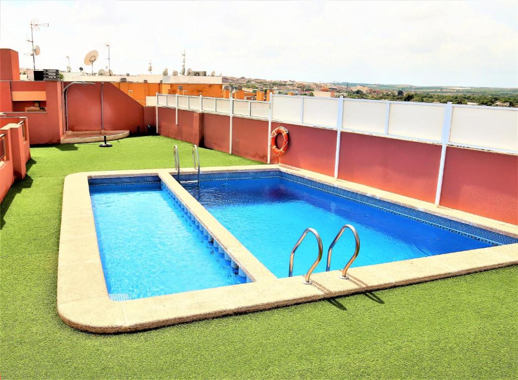 a swimming pool on the roof of a building at Apartment Segura 2BD in Rojales