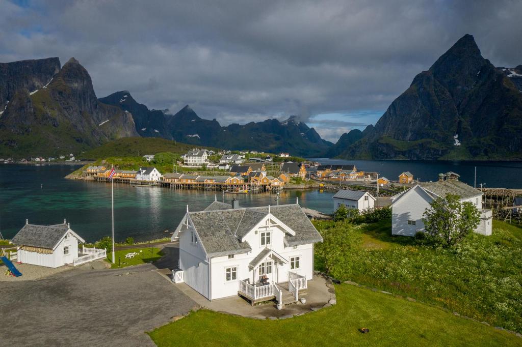 an aerial view of a house with mountains in the background at Lofoten Villa in Reine