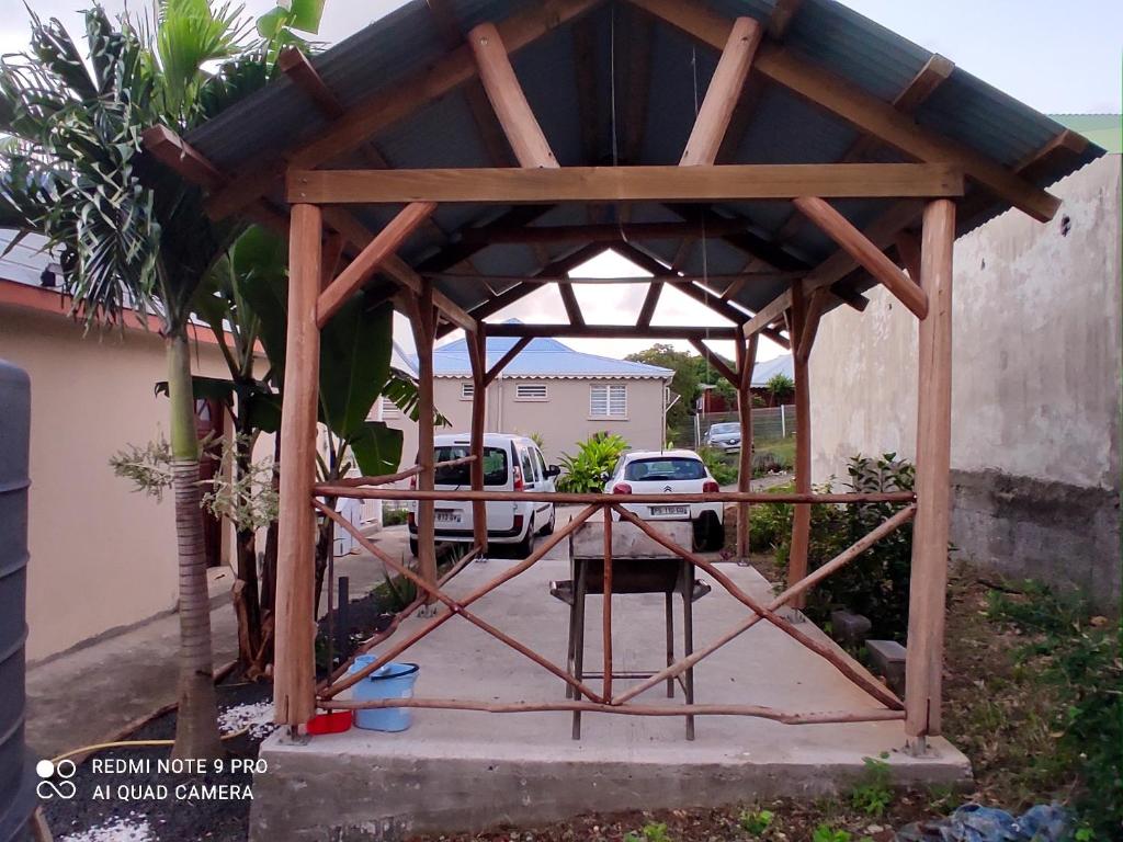 a wooden gazebo being constructed in a yard at Appartement de 3 chambres a Le Moule a 800 m de la plage avec piscine partagee et jardin clos in Le Moule