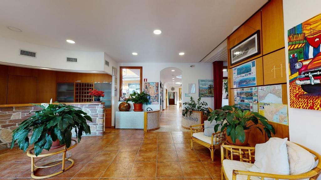 a lobby of a store with chairs and plants at Hotel Zunino in Spotorno