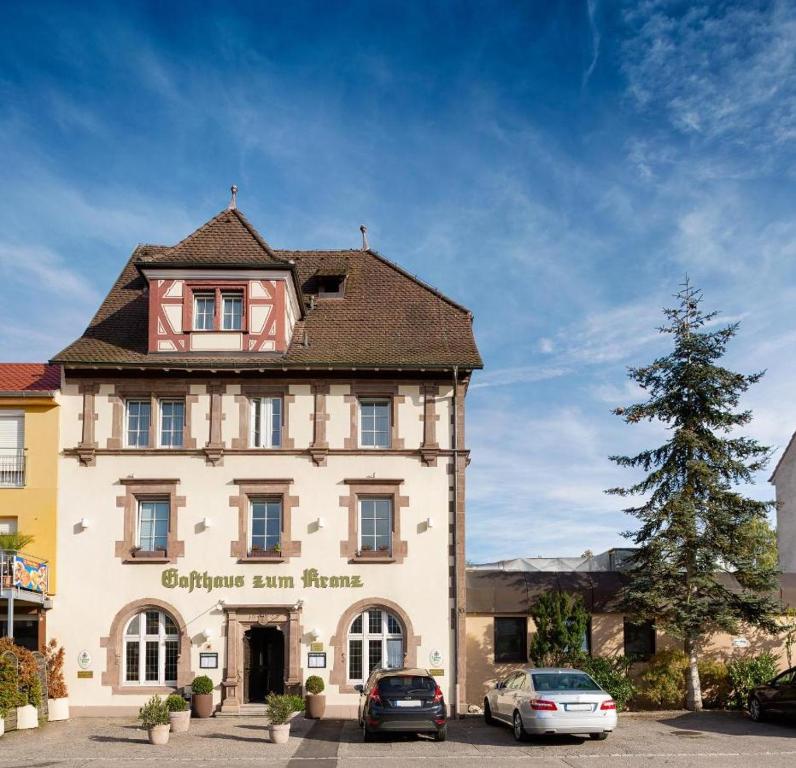 een gebouw waar auto's voor geparkeerd staan bij Gasthaus zum Kranz in Lörrach