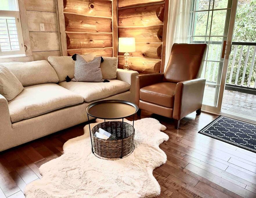 a living room with a couch and a chair at The Bruce Beach House - Cozy cottage by the lake! in Moraviantown