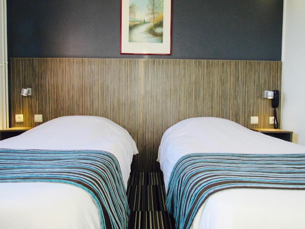 Postel nebo postele na pokoji v ubytování Hotel Bollaert
