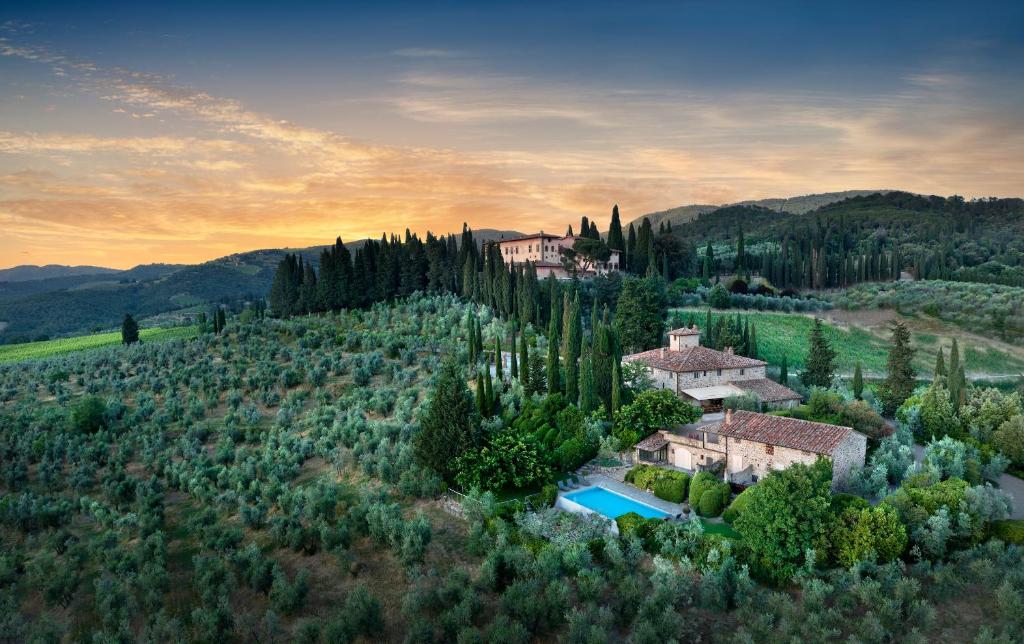 an aerial view of a house in the hills with trees at Casolese di Vignamaggio in Greve in Chianti