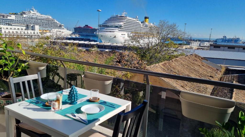 a table with two cruise ships in the harbor at Location10 in Palermo
