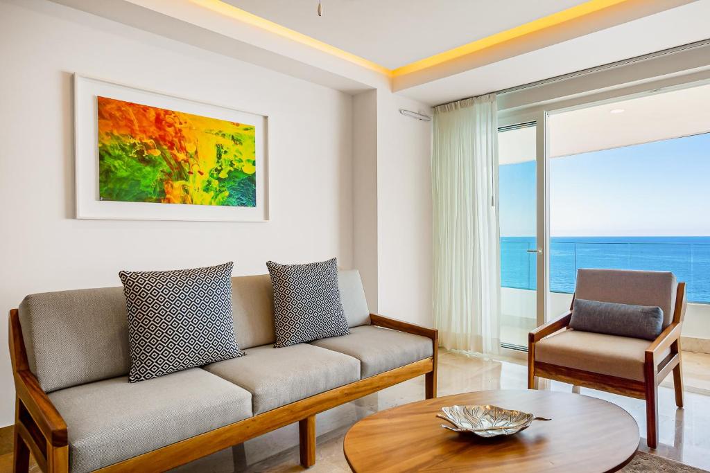 a living room with a couch and a table at Blue Horizon 802 in Puerto Vallarta