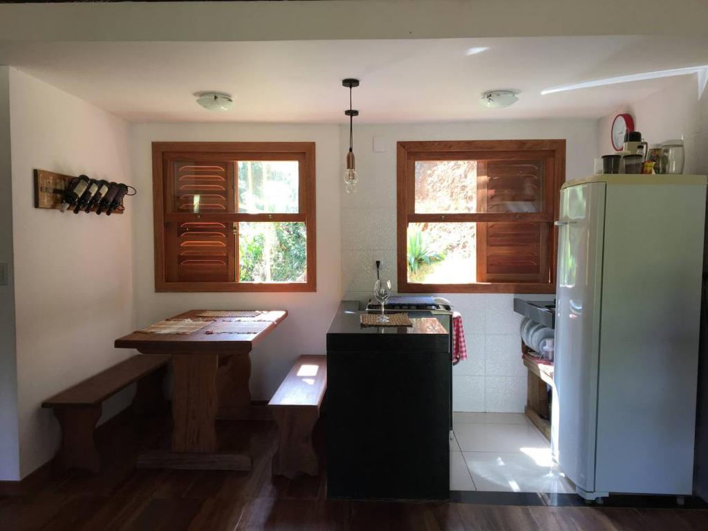 a kitchen with a refrigerator and a table in it at Brandt Huss in Santa Teresa