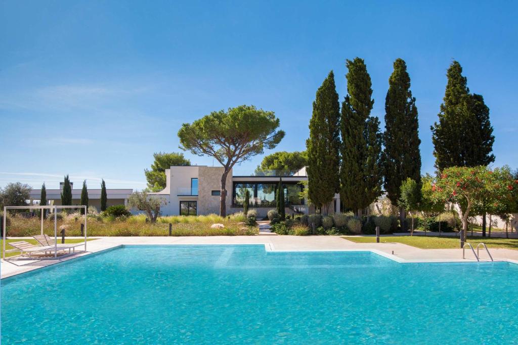 een zwembad voor een huis met bomen bij Villa Ottavia by Perle di Puglia in Porto Cesareo