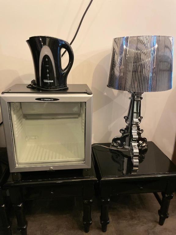 una lámpara y un televisor y una licuadora sobre una mesa en Thuis bij Schell, en Róterdam