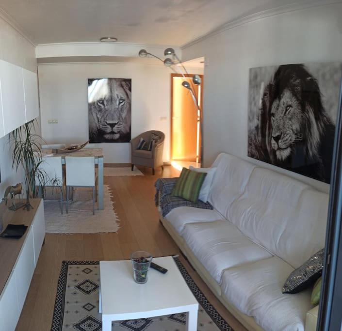 a living room with a white couch and a table at Ático en Paiporta con 2 grandes terrazas in Valencia