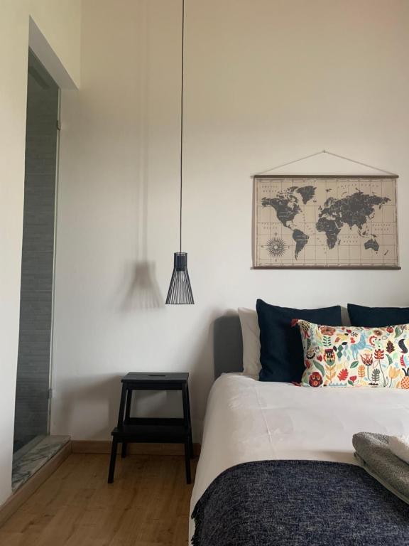 1 dormitorio con 1 cama y un mapa en la pared en Herdade Da Maridona - Agroturismo, en Estremoz