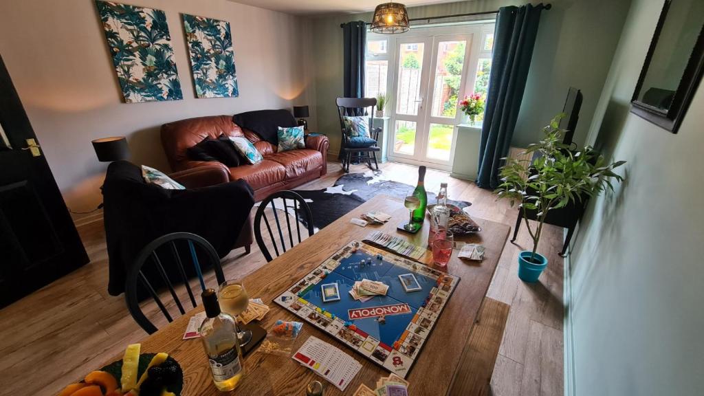 a living room with a table and a couch at The Farrier's by Spires Accommodation A convenient place to stay for exploring Cannock Chase in Hednesford