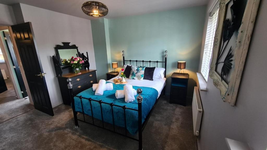 a bedroom with a bed with two teddy bears on it at The Farrier's 3 bedroom comfy and cosy bolt hold close to Cannock town centre in Hednesford