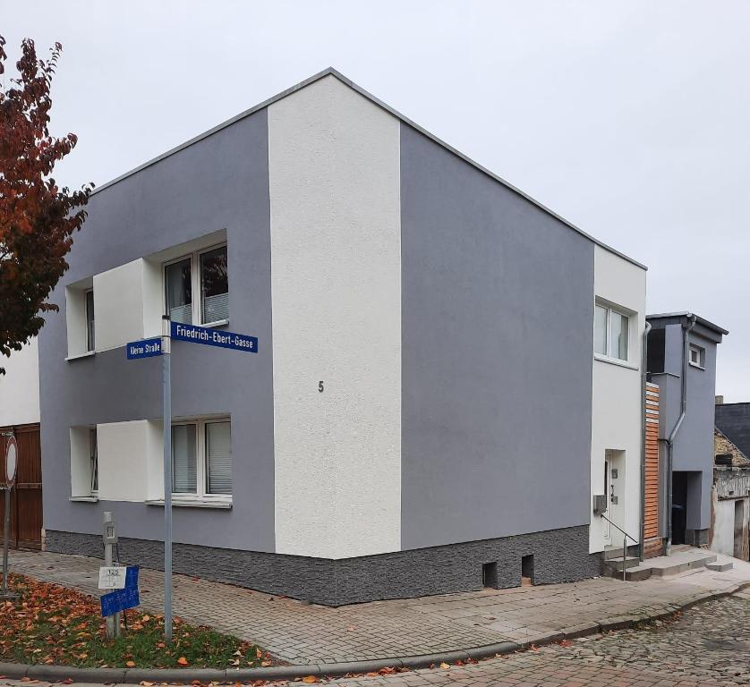 a white building with a street sign in front of it at Tina´s Fewo in Hohendodeleben