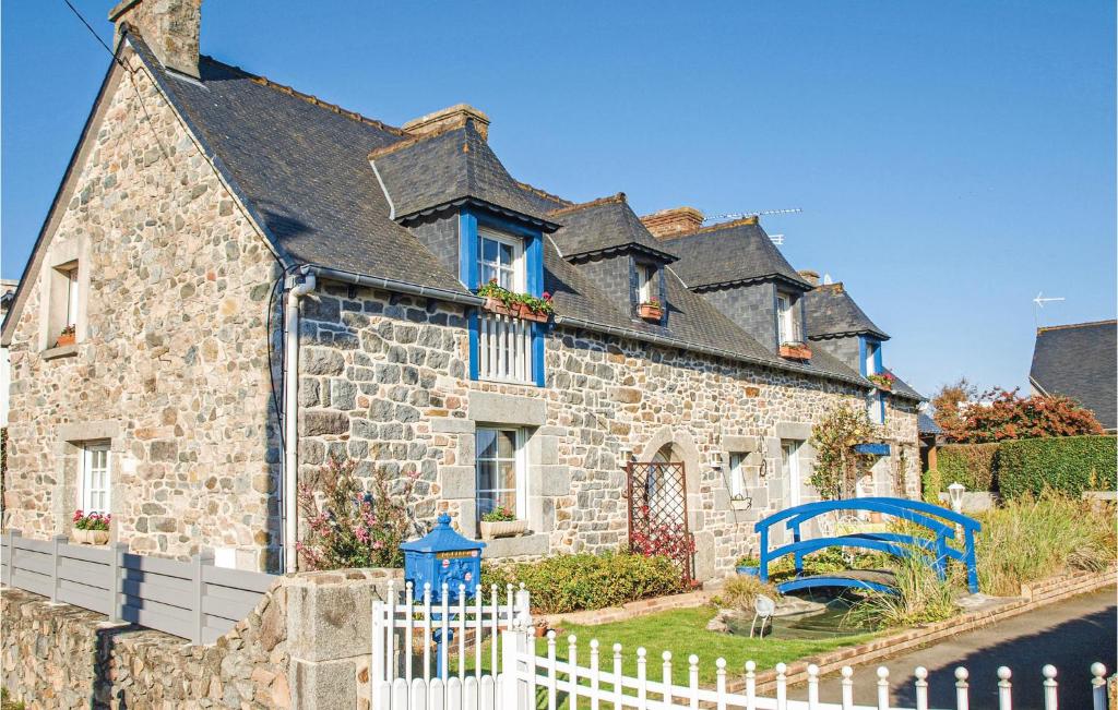 a stone house with a white fence in front of it at 4 Bedroom Lovely Home In Langueux in Langueux