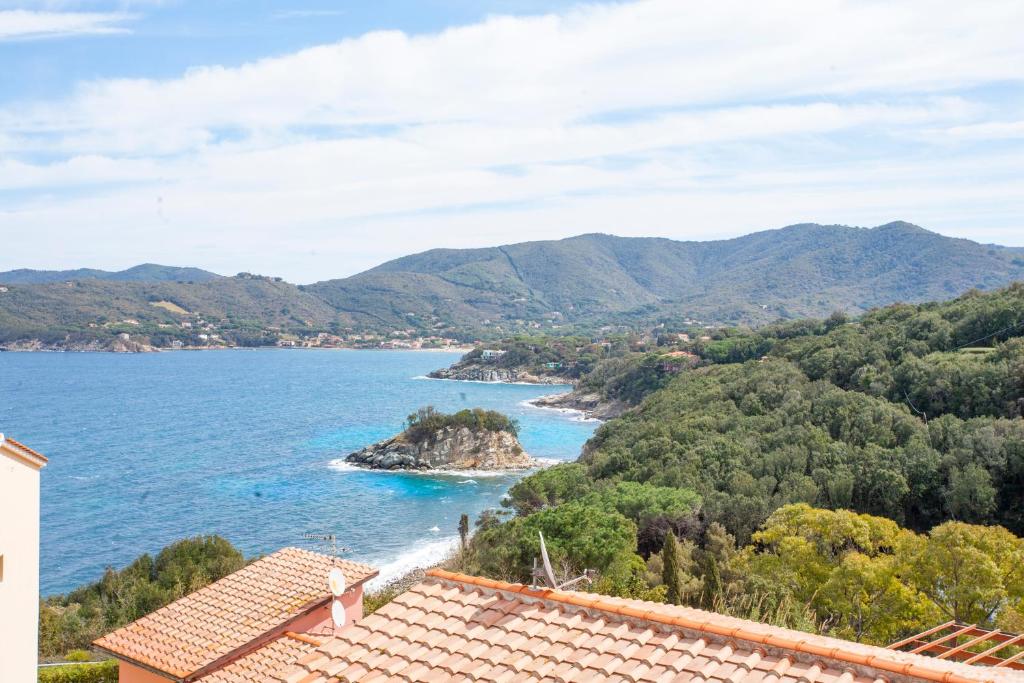 a view of the ocean from a house at La Paolina Vista Mare e Natura in Marciana Marina