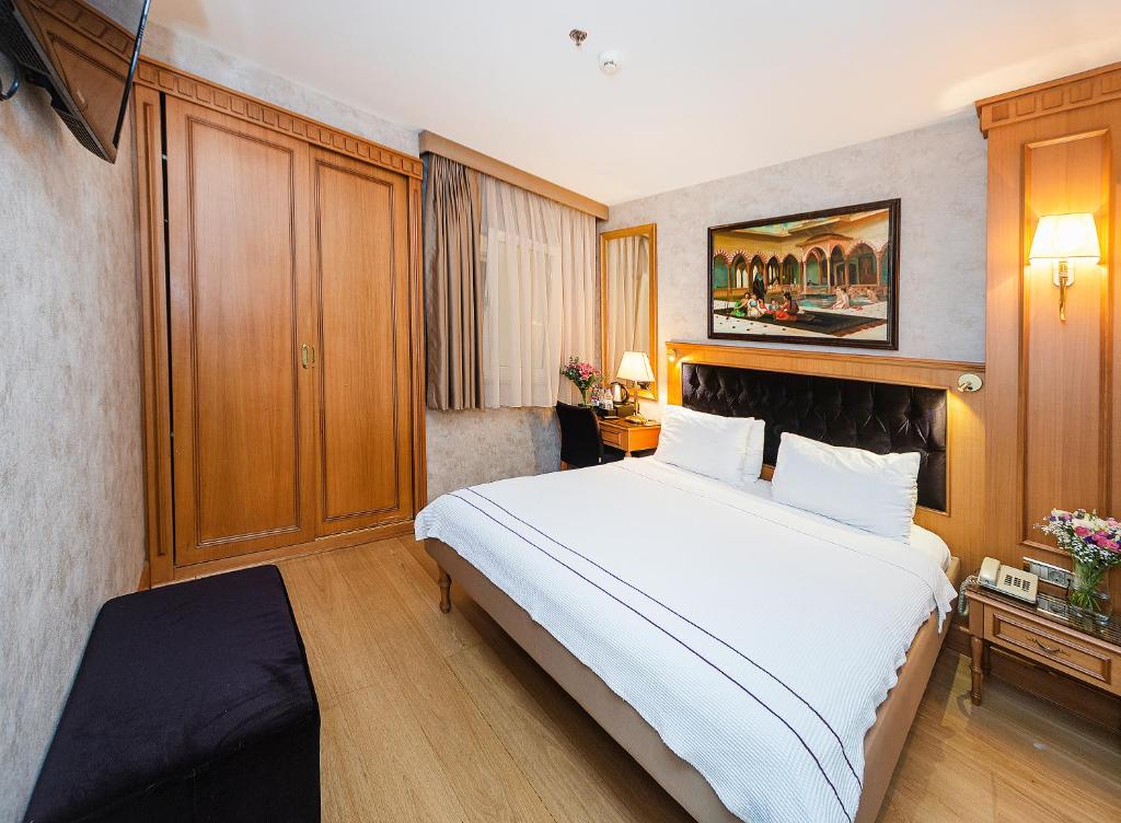 A bed or beds in a room at Aprilis Hotel - Special Category