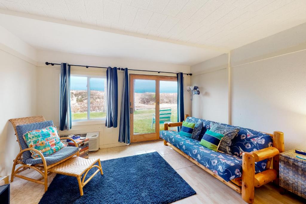 a living room with a couch and a chair at Tall Timber B-2 in Glen Arbor