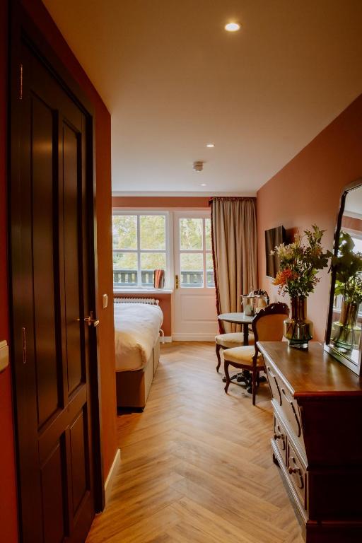Postel nebo postele na pokoji v ubytování Boetiekhotel De Kastanjehof