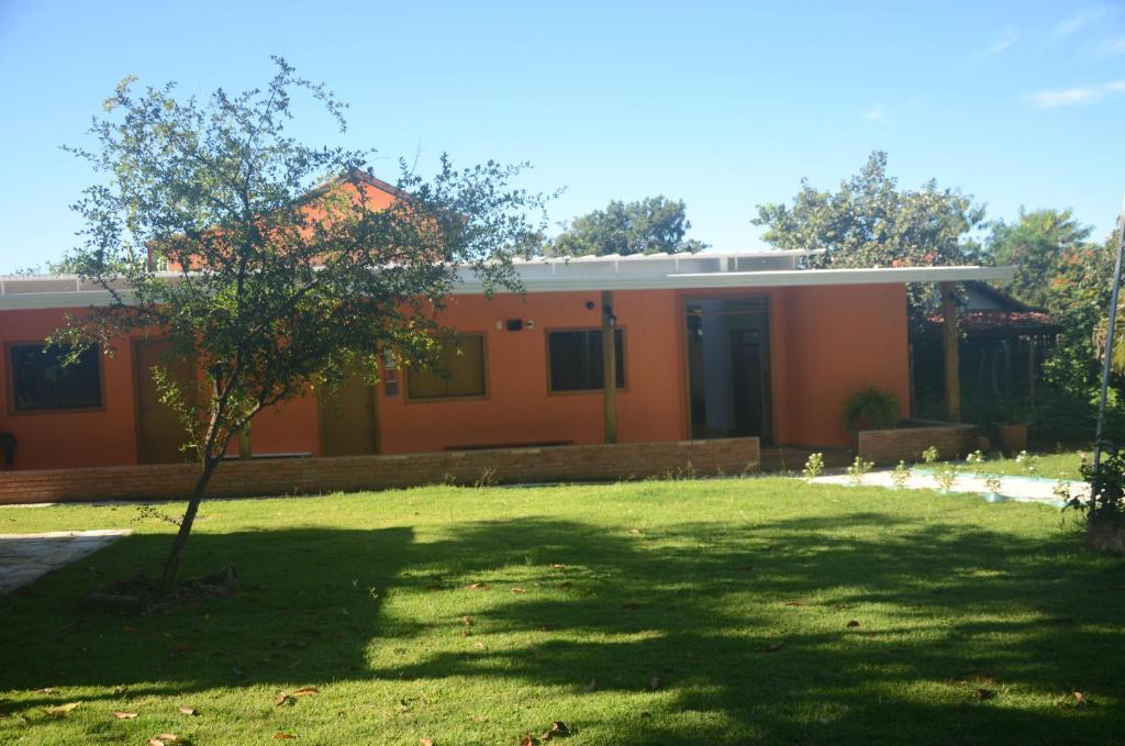 an orange house with a lawn in front of it at Amanduarte Brasília in Brasília