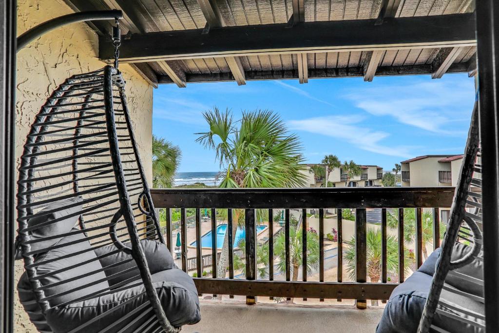 a hammock on a balcony with a view of the beach at Sunrise Escape in Saint Augustine