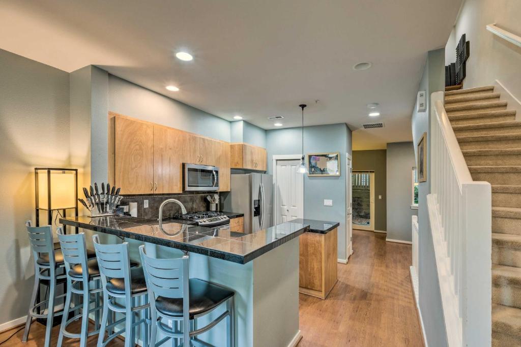 a kitchen with a counter and bar with stools at Quaint Issaquah Home - Walk to Shops and Dining in Issaquah