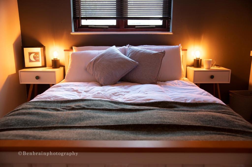 a bedroom with a bed with two lights on it at No31 Apartment Cardiff in Cardiff