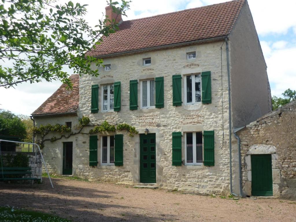 an old stone house with green shutters at Maison de ferme rénovée en pierre avec jardin, cheminée, WIFI, équipements bébé, animaux acceptés - FR-1-489-19 in Ébreuil