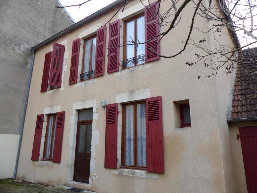 a building with red shutters on it at Gîte Saint-Germain-des-Fossés, 5 pièces, 8 personnes - FR-1-489-248 in Saint-Germain-des-Fossés