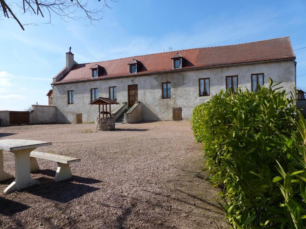 a building with a bench in front of it at Gîte Arfeuilles, 5 pièces, 11 personnes - FR-1-489-280 in Arfeuilles