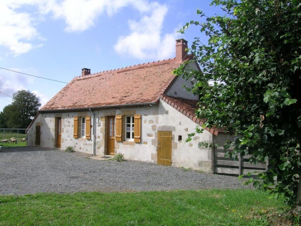 a small white cottage with a red roof at Charmante fermette au vert près de la forêt de Tronçais, 2 chambres, animaux acceptés, linge inclus - FR-1-489-311 in Vieure