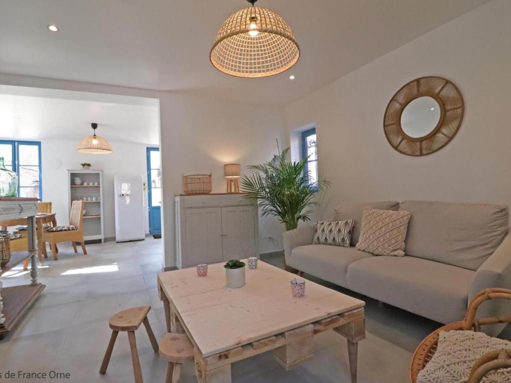 a living room with a couch and a table at Gîte Sap-en-Auge, 4 pièces, 5 personnes - FR-1-497-146 in Le Sap